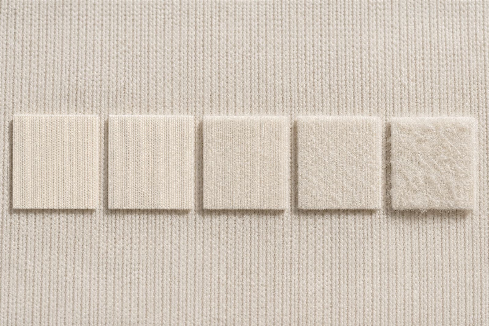 Five squares of the same fabric showing progressively more surface fuzz